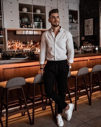 Beige Vertical Striped Long Sleeve Shirt Outfits For Men: A beige vertical striped long sleeve shirt looks so great when combined with black chinos in a casual outfit. A pair of white leather low top sneakers can integrate well within a great deal of combos.