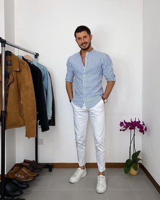 White and Blue Vertical Striped Long Sleeve Shirt Outfits For Men: For a tested casual option, you can rely on this pairing of a white and blue vertical striped long sleeve shirt and white chinos. White leather low top sneakers look great completing your outfit.
