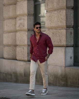 Burgundy Shirt Summer Outfits For Men: A burgundy shirt and beige chinos have become a go-to combo for many style-conscious gentlemen. You could perhaps get a bit experimental when it comes to shoes and introduce a pair of brown suede low top sneakers to this look. You totally can look easy breezy under the summer heat. The proof is right here