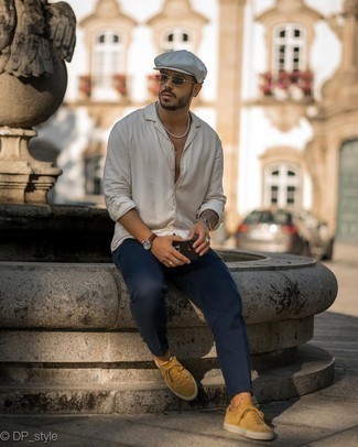 Mustard Low Top Sneakers Outfits For Men: Prove that you do off-duty like a fashion pro in a white long sleeve shirt and navy chinos. Dress down your look by slipping into a pair of mustard low top sneakers.