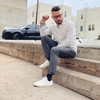 White and Brown Long Sleeve Shirt Outfits For Men: Teaming a white and brown long sleeve shirt and grey chinos will hallmark your prowess in men's fashion even on off-duty days. Dial down the classiness of this ensemble with white canvas low top sneakers.