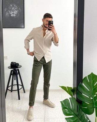 Beige Long Sleeve Shirt Outfits For Men: Marrying a beige long sleeve shirt with olive chinos is a good pick for a casual ensemble. And if you wish to immediately dress down your outfit with footwear, why not slip into a pair of beige suede low top sneakers?