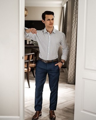 White and Black Check Long Sleeve Shirt Outfits For Men: Display your skills in menswear styling in this casual combination of a white and black check long sleeve shirt and navy chinos. Break up this getup with a more refined kind of shoes, such as these dark brown leather oxford shoes.
