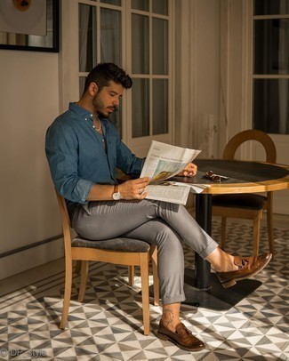 Brown Leather Tassel Loafers Outfits: Look stylish yet functional by opting for a navy chambray long sleeve shirt and grey chinos. Get a bit experimental on the shoe front and complement your ensemble with a pair of brown leather tassel loafers.