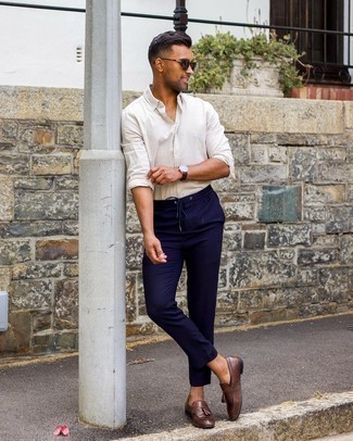 Navy Chinos Outfits: This pairing of a white long sleeve shirt and navy chinos is extremely easy to pull together and so comfortable to wear as well! Why not opt for a pair of dark brown leather tassel loafers for an added touch of style?
