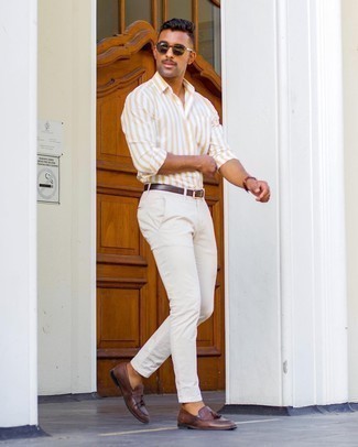 White Chinos Outfits: When comfort is everything, this combination of a yellow vertical striped long sleeve shirt and white chinos is a no-brainer. For a modern on and off-duty mix, complement this outfit with a pair of dark brown leather tassel loafers.