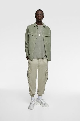 1200+ Casual Outfits For Men: Dress in an olive long sleeve shirt and beige cargo pants to create an extra sharp and modern-looking off-duty ensemble. Here's how to give a more relaxed aesthetic to this look: white athletic shoes.