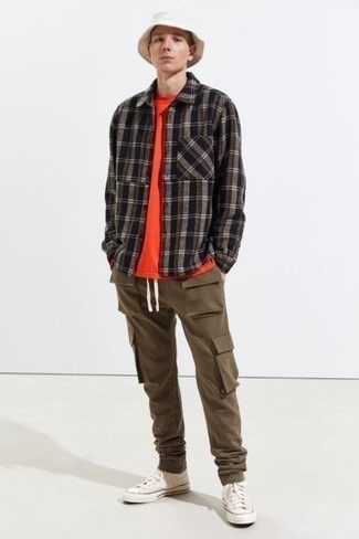 Dark Brown Plaid Flannel Long Sleeve Shirt Outfits For Men: To create a laid-back ensemble with a modern twist, pair a dark brown plaid flannel long sleeve shirt with brown cargo pants. Finishing with white canvas high top sneakers is an effective way to add a sense of stylish nonchalance to this outfit.