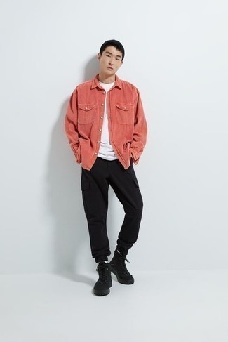 Pink Long Sleeve Shirt Outfits For Men: Showcase your prowess in men's fashion by combining a pink long sleeve shirt and black cargo pants for a casual ensemble. Introduce a pair of black canvas high top sneakers to the mix to bring a touch of stylish nonchalance to this getup.