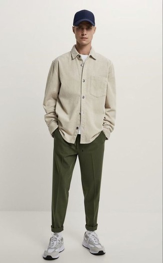 Olive Chinos Outfits: For a surefire off-duty option, you can always rely on this combination of a beige long sleeve shirt and olive chinos. Avoid looking overdressed by finishing off with grey athletic shoes.