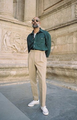 Beige Chinos Outfits: When the setting permits a casual look, you can rely on a dark green long sleeve shirt and beige chinos. Add a fun feel to this look by rounding off with a pair of white canvas low top sneakers.