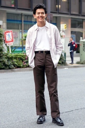 Pink Long Sleeve Shirt Outfits For Men: This combo of a pink long sleeve shirt and dark brown chinos is solid proof that a simple off-duty outfit doesn't have to be boring. Complete this ensemble with a pair of black leather desert boots and the whole ensemble will come together.
