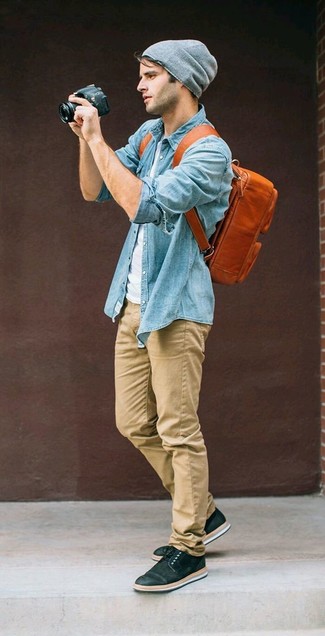 Dark Brown Leather Backpack Outfits For Men: Marry a light blue chambray long sleeve shirt with a dark brown leather backpack for a laid-back look with a city style finish. Add black low top sneakers to the mix to completely change up the getup.