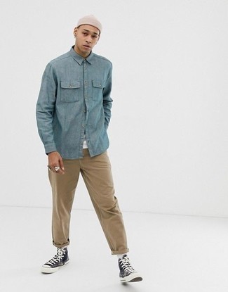 Light Blue Long Sleeve Shirt with Khaki Chinos Outfits: Such essentials as a light blue long sleeve shirt and khaki chinos are the ideal way to introduce extra cool into your day-to-day casual lineup. In the footwear department, go for something on the laid-back end of the spectrum with black and white canvas high top sneakers.