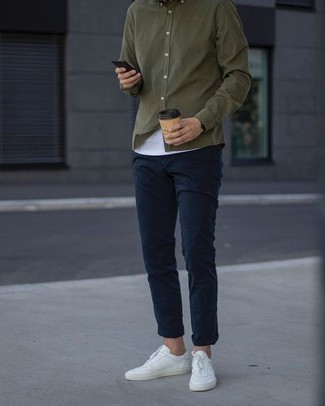 Dark Green Long Sleeve Shirt Outfits For Men: You'll be surprised at how easy it is for any man to put together this off-duty ensemble. Just a dark green long sleeve shirt and navy chinos. You can take a more laid-back approach with shoes and complement your ensemble with a pair of white canvas low top sneakers.