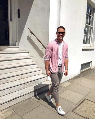 Pink Polka Dot Long Sleeve Shirt Outfits For Men: Opt for a pink polka dot long sleeve shirt and grey chinos for a casually edgy and fashionable outfit. A pair of white canvas low top sneakers complements this getup quite nicely.