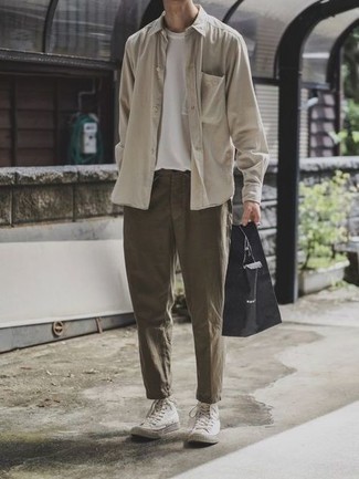 Brown Chinos Outfits: Make a beige long sleeve shirt and brown chinos your outfit choice for a functional look that's also well-executed. To inject a dose of stylish casualness into this ensemble, add a pair of white canvas high top sneakers.