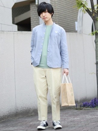 Beige Chinos Warm Weather Outfits: Try teaming a light blue long sleeve shirt with beige chinos for a fuss-free outfit that's also put together. Bring a fun touch to this look with a pair of black and white canvas low top sneakers.