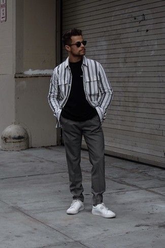 White and Black Vertical Striped Long Sleeve Shirt Outfits For Men: A white and black vertical striped long sleeve shirt and charcoal chinos are a favorite combo for many trendsetting gentlemen. Introduce a pair of white leather low top sneakers to your look for maximum effect.