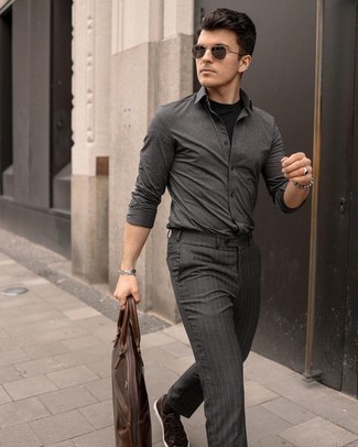 Tobacco Leather Tote Bag Outfits For Men: Try pairing a charcoal long sleeve shirt with a tobacco leather tote bag to put together a casual street style and stylish look. A pair of dark brown leather low top sneakers immediately ups the classy factor of this getup.