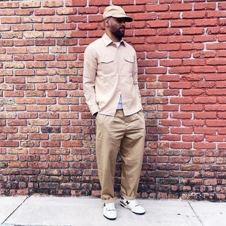 Beige Baseball Cap Outfits For Men: Marry a beige long sleeve shirt with a beige baseball cap to feel 100% confident and look fashionable. For something more on the classier end to round off your getup, add white and black leather low top sneakers to the mix.