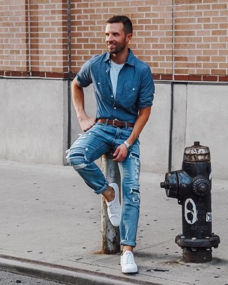 Blue Chambray Long Sleeve Shirt Outfits For Men: Combining a blue chambray long sleeve shirt with blue ripped jeans is a savvy choice for an off-duty yet stylish outfit. White low top sneakers are guaranteed to breathe a hint of sophistication into this getup.