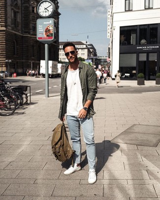 Olive Canvas Backpack Outfits For Men: A dark green long sleeve shirt and an olive canvas backpack are absolute essentials if you're figuring out a casual closet that matches up to the highest menswear standards. With shoes, you can go down a more elegant route with a pair of white low top sneakers.