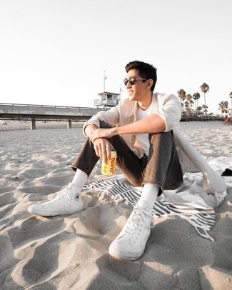 1200+ Casual Hot Weather Outfits For Men: A grey linen long sleeve shirt and charcoal jeans are both versatile menswear must-haves that will integrate really well within your daily casual collection. White canvas high top sneakers will bring an easy-going vibe to this look.