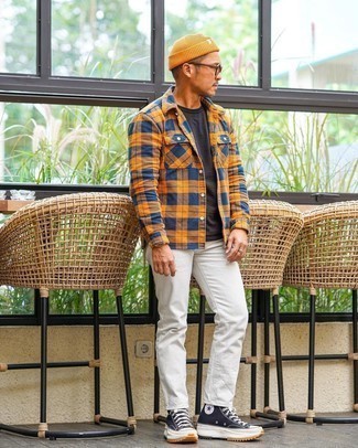 Mustard Beanie Outfits For Men: For a look that's super simple but can be flaunted in a ton of different ways, opt for a multi colored plaid flannel long sleeve shirt and a mustard beanie. Up the ante of your outfit by rounding off with a pair of black and white canvas high top sneakers.