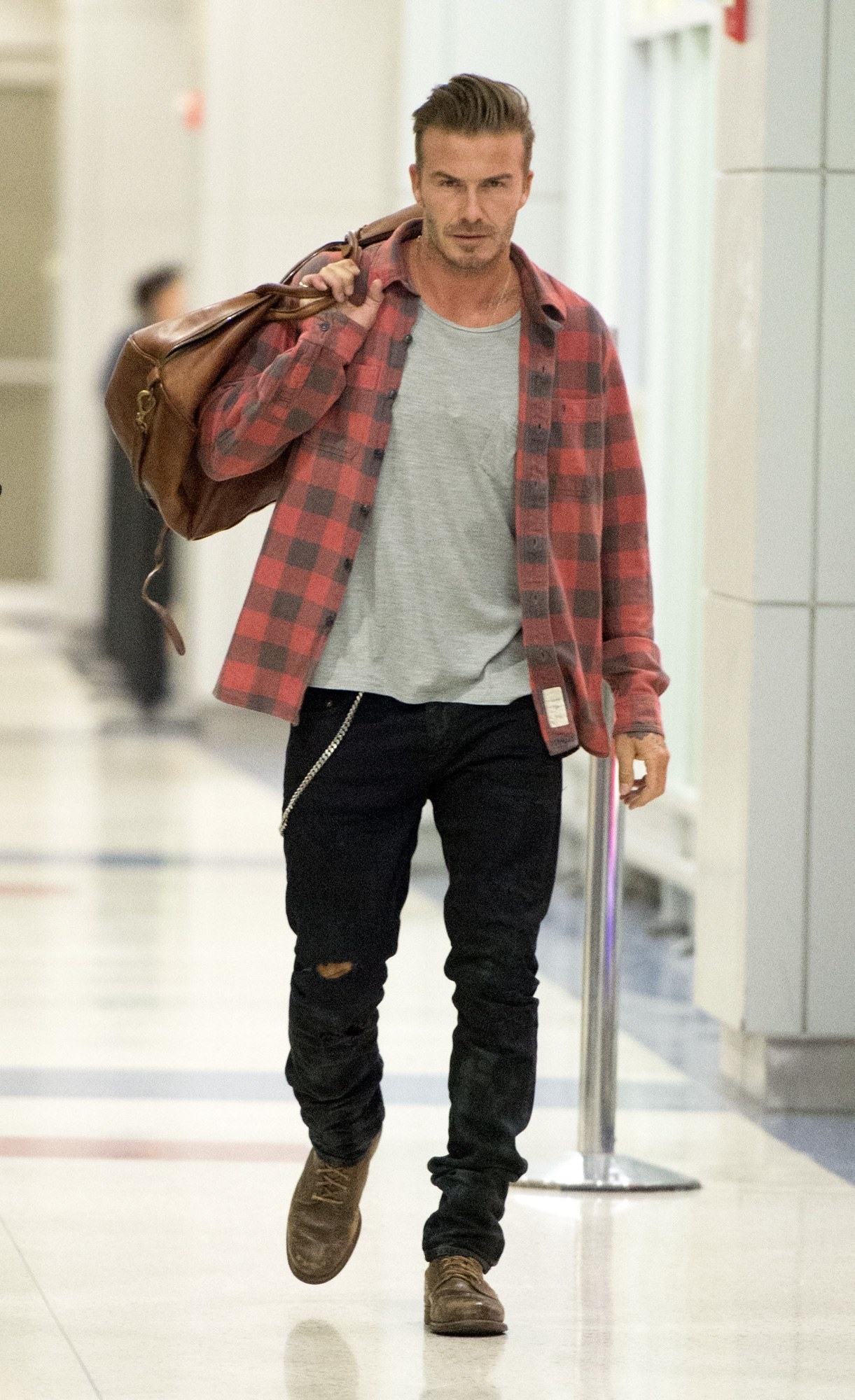David Beckham wearing Red and Black Check Flannel Long Sleeve Shirt, Grey Crew-neck T-shirt, Black Jeans, Brown Leather Casual Boots | Lookastic