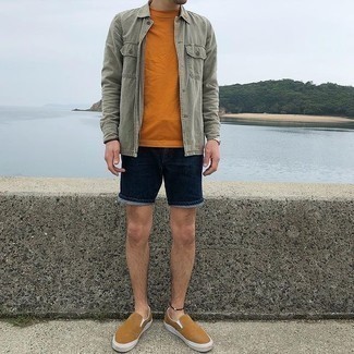 Orange Crew-neck T-shirt Outfits For Men: An orange crew-neck t-shirt and navy denim shorts worn together are a sartorial dream for those dressers who prefer casually dapper getups. Introduce a pair of tan canvas slip-on sneakers to the mix for an instant style upgrade.