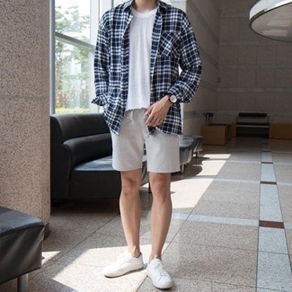Navy and White Plaid Long Sleeve Shirt Outfits For Men: You'll be amazed at how easy it is for any gentleman to throw together this casual outfit. Just a navy and white plaid long sleeve shirt and grey shorts. Go for white canvas low top sneakers and the whole getup will come together.