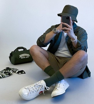 Dark Green Bucket Hat Outfits For Men: For an ensemble that's super easy but can be modified in a multitude of different ways, marry a dark green long sleeve shirt with a dark green bucket hat. Our favorite of a variety of ways to finish this ensemble is with white print canvas low top sneakers.