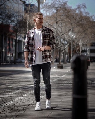 Black and White Plaid Long Sleeve Shirt Outfits For Men: This pairing of a black and white plaid long sleeve shirt and charcoal ripped skinny jeans is a safe bet for an effortlessly stylish outfit. Why not take a classic approach with footwear and introduce a pair of white leather low top sneakers to your look?