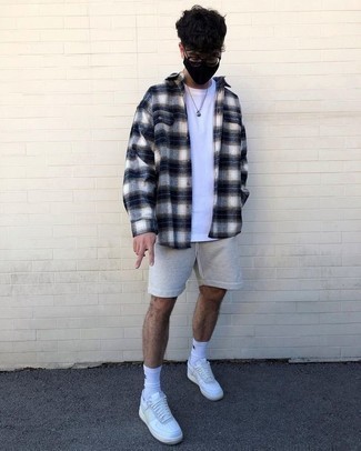 Navy and White Plaid Flannel Long Sleeve Shirt Outfits For Men: A navy and white plaid flannel long sleeve shirt and grey sports shorts will add serious style to your off-duty styling arsenal. If you feel like dialing it up a bit now, complement this look with a pair of white leather low top sneakers.