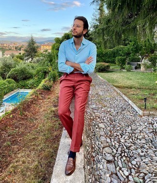 Red Dress Pants Outfits For Men: Pair a light blue vertical striped long sleeve shirt with red dress pants for seriously smart attire. Brown leather loafers will breathe an element of class into an otherwise standard ensemble.
