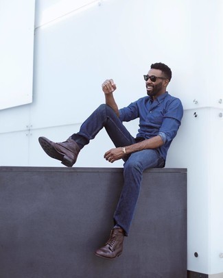 Men's Navy Chambray Long Sleeve Shirt, Navy Jeans, Dark Brown Leather Casual Boots, Dark Green Sunglasses