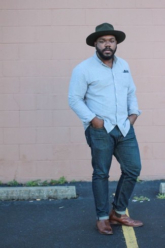 Dark Green Wool Hat Outfits For Men: No matter where the day takes you, you'll be stylishly ready in this laid-back combo of a light blue chambray long sleeve shirt and a dark green wool hat. Our favorite of a ton of ways to finish off this ensemble is with brown leather chelsea boots.