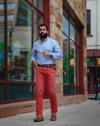 Red Jeans Outfits For Men: If you feel more confident wearing something functional, you'll like this stylish pairing of a light blue long sleeve shirt and red jeans. Let your styling expertise truly shine by completing your getup with brown suede driving shoes.