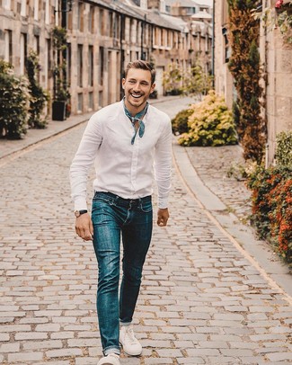 White Linen Long Sleeve Shirt Outfits For Men: A white linen long sleeve shirt and blue jeans are essential in any guy's versatile off-duty wardrobe. For maximum effect, complement your getup with white canvas low top sneakers.