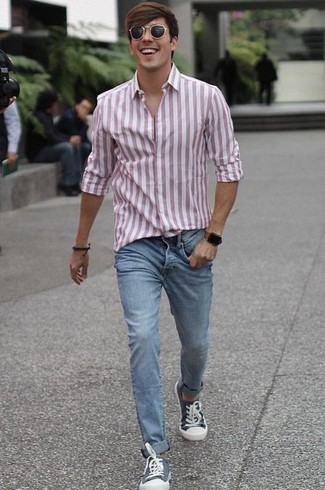 Blue Canvas Low Top Sneakers Outfits For Men: Reach for a pink vertical striped long sleeve shirt and light blue jeans to achieve an everyday look that's full of charisma and personality. A pair of blue canvas low top sneakers is a good option to complete your ensemble.