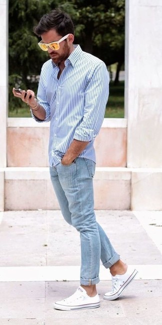 Men's White and Blue Vertical Striped Long Sleeve Shirt, Light Blue Jeans, White Canvas Low Top Sneakers, Mustard Sunglasses