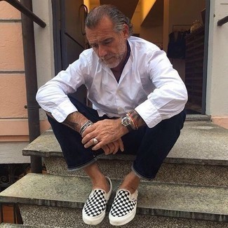 Black and White Check Canvas Slip-on Sneakers Outfits For Men: A white long sleeve shirt and navy jeans are the kind of a winning casual look that you so terribly need when you have no extra time. Add black and white check canvas slip-on sneakers to the equation and you're all set looking killer.