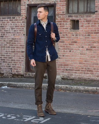 Dark Brown Leather Backpack Outfits For Men: If you're looking for a contemporary yet on-trend look, try teaming a grey long sleeve shirt with a dark brown leather backpack. And if you need to instantly smarten up this getup with one single piece, why not complete this outfit with dark brown suede casual boots?