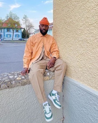 White and Green Leather Low Top Sneakers Outfits For Men: One of the best ways for a man to style an orange long sleeve shirt is to team it with khaki chinos in a laid-back combination. For a more relaxed take, complement this look with a pair of white and green leather low top sneakers.