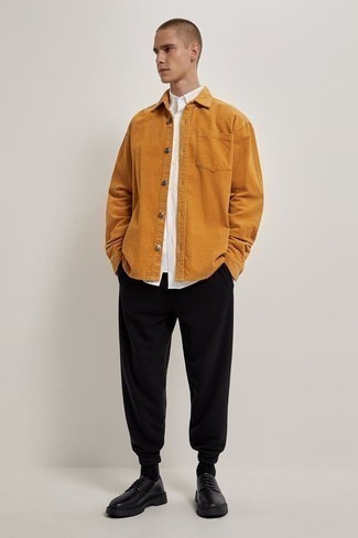 Orange Corduroy Long Sleeve Shirt Outfits For Men: You'll be surprised at how easy it is for any gent to throw together this relaxed ensemble. Just an orange corduroy long sleeve shirt and black sweatpants. Black leather derby shoes will take your getup in a more elegant direction.