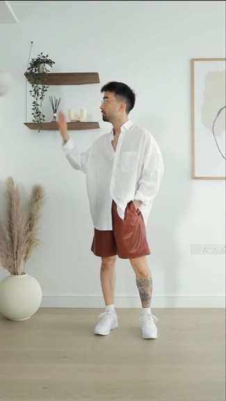 White Long Sleeve Shirt Outfits For Men: A white long sleeve shirt and brown leather shorts are absolute menswear must-haves if you're planning an off-duty wardrobe that holds to the highest sartorial standards. Send an otherwise traditional ensemble a more informal path by finishing with a pair of white athletic shoes.