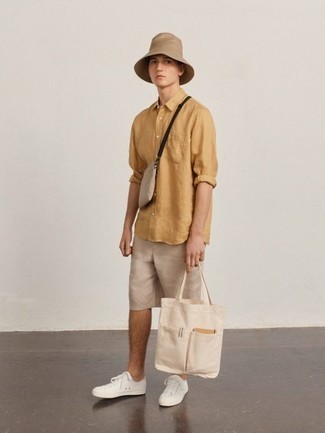 Tan Bucket Hat Outfits For Men: For a casually cool ensemble, opt for a tan linen long sleeve shirt and a tan bucket hat — these pieces go beautifully together. Dial down the casualness of your look by rounding off with a pair of white leather low top sneakers.