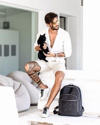 Navy Backpack Outfits For Men: To create a casual look with a contemporary twist, you can easily dress in a white long sleeve shirt and a navy backpack. Let your sartorial savvy truly shine by completing your outfit with white canvas low top sneakers.