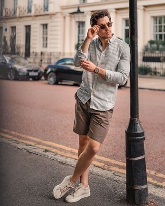Beige Suede Low Top Sneakers Outfits For Men: Consider pairing a grey vertical striped long sleeve shirt with brown shorts to achieve an interesting and modern-looking off-duty outfit. On the shoe front, this outfit is finished off perfectly with beige suede low top sneakers.